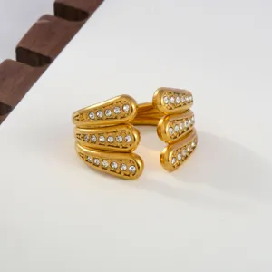 Detail view of golden stainless steel open ring adorned with sparkling cubic zirconia stones.