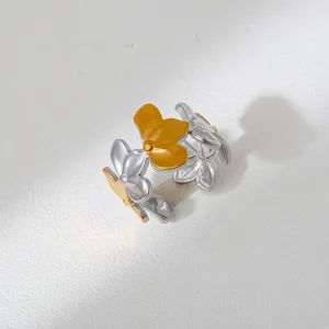 Detailed close-up of the two-tone stainless steel multi-flower open ring surface texture.