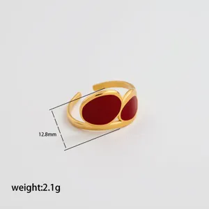 Stainless steel open adjustable ring with wine red enamel, minimalist luxury jewelry detail view.