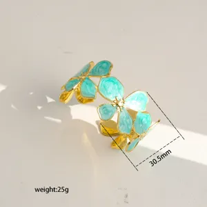 Close-up detail of the blue enamel flower bracelet, showing 30.5mm size and 25g lightweight.