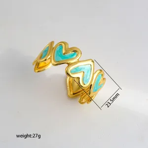 Gold-plated open cuff bracelet featuring handmade blue enamel hearts stylish fashion jewelry
