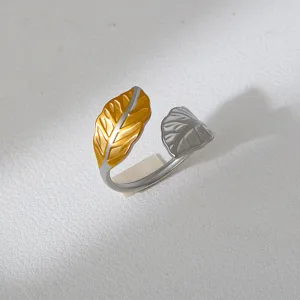 Close-up detail of the two-tone leaf open ring, showing the exquisite gold and silver texture.