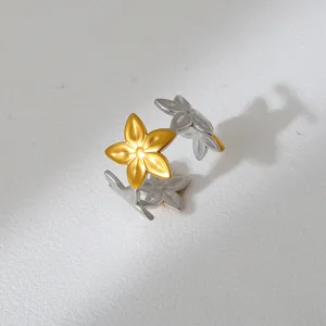 Close-up of a two-tone stainless steel flower ring featuring a gold blossom and silver band.