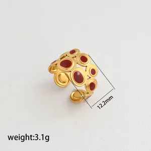 Gold stainless steel open ring with red enamel circles. Detail view showing 12.2mm width, 3.1g.