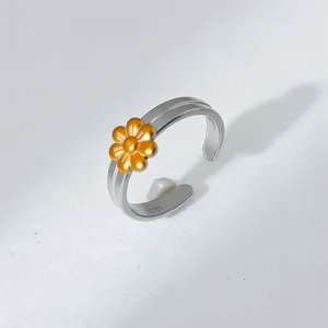 Detailed view of the stylish silver and gold dual-color floral open ring, perfect accessory.