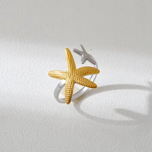 Exquisite double-color starfish ring featuring gold and silver tones, unique open design.