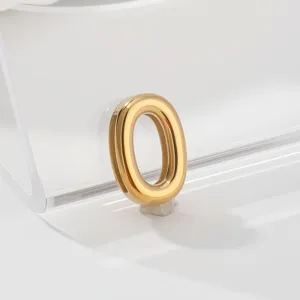 Gold stainless steel number 0 charm pendant detail shot, minimalist jewelry accessory display.
