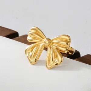 Gold bow stainless steel ring detail shot, elegant and versatile fashion finger jewelry.