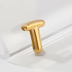 Gold stainless steel letter T pendant charm detail showing polished smooth metallic finish.