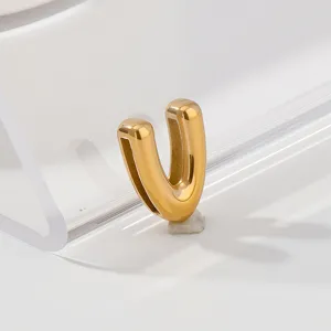 Close-up detail of a shiny gold letter V pendant, elegant metallic gloss and smooth finish.