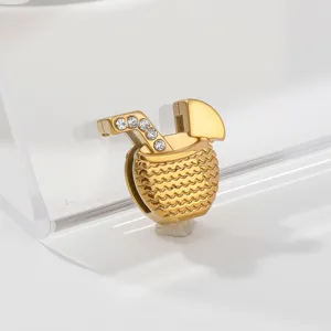Detailed close-up of a gold-plated cocktail drink charm pendant with sparkling cubic zirconia.