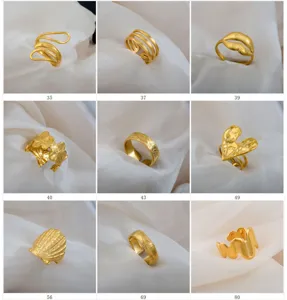 Detail view of assorted gold stainless steel adjustable rings showing various unique fashion design