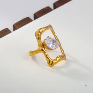 Stainless steel ring detail showing the shimmering white cubic zirconia and irregular gold frame.
