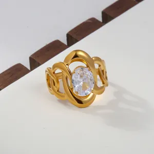 Close-up of a chic 18k gold stainless steel open ring with oval cubic zirconia and elegant cutout details.