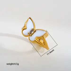 Stainless steel butterfly ring with white mother-of-pearl and zircon detail close-up.