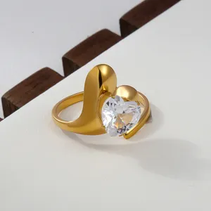 Detail view of a luxury gold stainless steel ring with a sparkling heart-shaped zirconia.