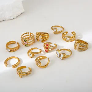 Details of stylish stainless steel gold open rings set with sparkling zirconia and cute charms.