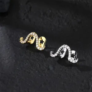 Close-up of sparkling star cutout grillz in gold and silver, detailed pavé zirconia stones.
