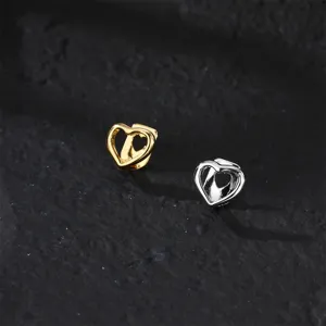 Detailed close-up shot of hollow heart grillz, featuring gold and silver teeth accessories.