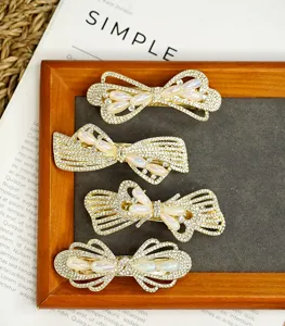 Gold rhinestone bow hair clips with faux pearls, elegant spring hairpin for women's daily hair styling.