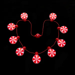 Detail shot of Christmas candy LED string lights, glowing peppermint pendant for holiday party.