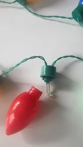 Close-up detail showing the internal LED bulb structure and green wire of Christmas string lights.
