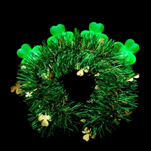 Close-up detail of St. Patrick's Day glowing shamrock headband with green tinsel and lights.