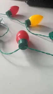 Close-up detail of colorful C9 Christmas bulb string light pendant for festive party decor.