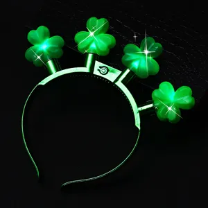 Close-up detail of St. Patrick's Day green glowing shamrock headband with LED lights.