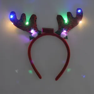 Détail de bois de renne clignotant LED, serre-tête de Noël à sequins rouges lumineux.