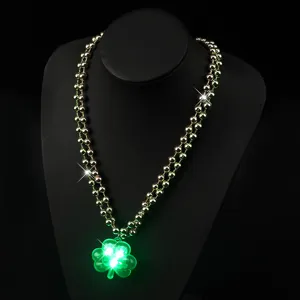 St. Patrick's Day green beaded LED light-up shamrock necklace detail view showing glowing clover.