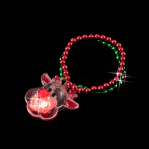 Christmas light-up reindeer bracelet with red green beads flashing LED elk charm detail view.