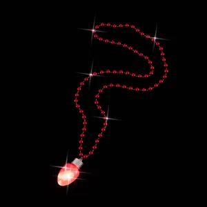 Close-up detail of the red LED light-up bulb pendant and shiny bead chain for Christmas decor.