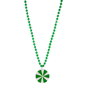 Green beaded necklace with a round green and white pendant, holiday party accessory detail.