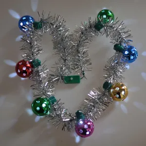 Colorful LED disco ball tinsel garland light necklace, glowing holiday party hanging decor detail.
