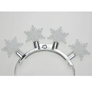 Close-up detail of silver glowing snowflake headband with four decorative lights for party.