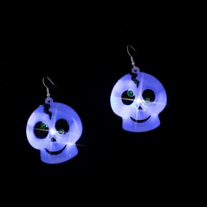 Halloween glowing skull earrings with green eyes and LED light effects for party.