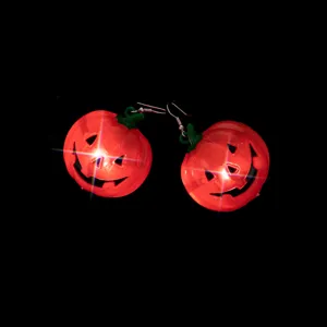 Detailed view of LED glowing pumpkin earrings for Halloween parties, unique holiday accessory.