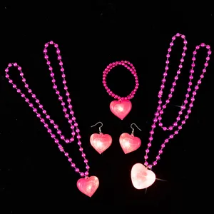 Pink LED glowing heart jewelry set including necklaces, bracelet, and earrings for parties.