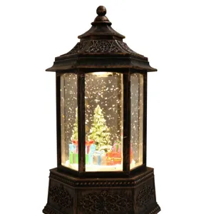 Christmas snow globe lantern decoration with LED lights, glowing tree and floating glitter snow.