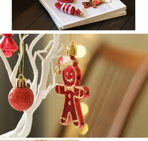Christmas tree hanging ornaments red gingerbread man and glitter balls holiday party decor.