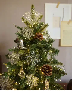 Mini Weihnachtsbaum Detail mit Kristall Schneeflocken und warmen Lichtern fuer Deko.