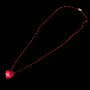 Close-up detail of the glowing heart pendant necklace, featuring bright red LED light effect.