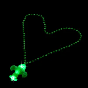 Detailed view of the LED glowing fleur-de-lis pendant bead necklace for carnival party.