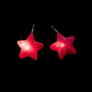 Close-up detail shot of glowing red star earrings with LED lights, perfect for party night events.