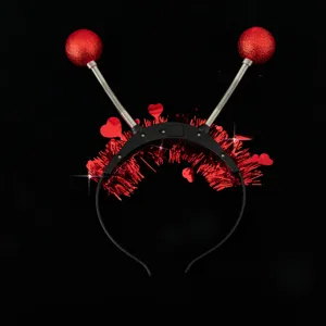 LED light-up spring ball headband detail, red heart tinsel party hair accessory closeup