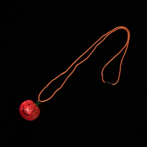 Halloween pumpkin LED glowing necklace detail view, featuring a cute pendant and orange cord.