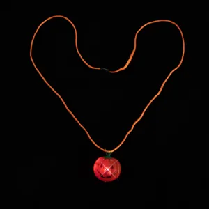 LED Halloween pumpkin necklace with glowing red pendant and orange cord for party props and events