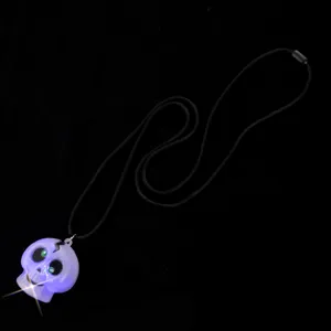 Halloween glowing purple skull necklace LED light up pendant party jewelry detail view.