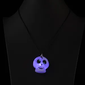 Close-up detail of the glowing Halloween skull pendant necklace with led lights on display.